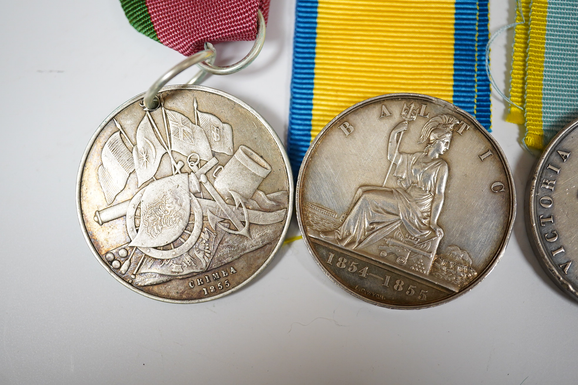 Two Crimea medals, a Baltic medal, all disc only and unnamed with a replica Turkish Crimea medal, unnamed, (3).